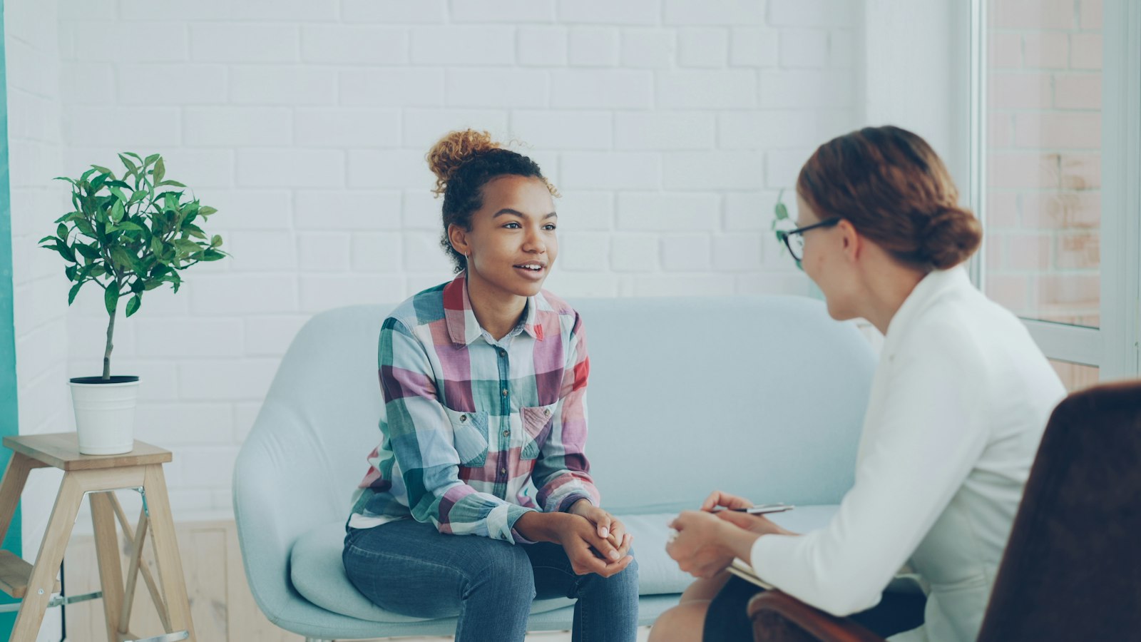 A patient talking with a doctor in a bright room