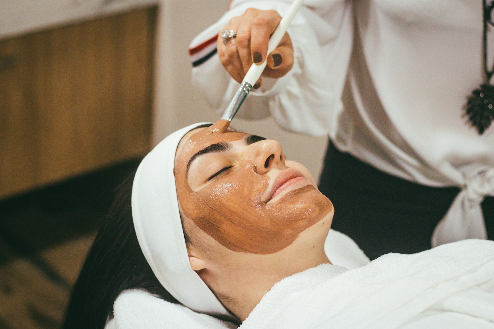 A facial with a clay mask in a skin clinic